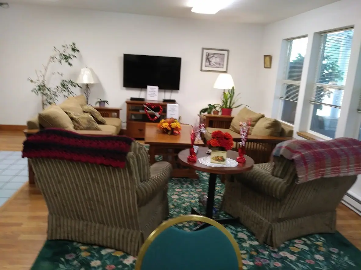Community room with sofas, armchairs and a television