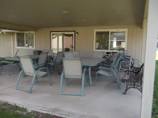 Covered patio with tables, chairs and bicycles
