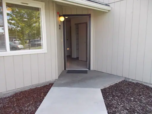 Walkway to an open apartment door