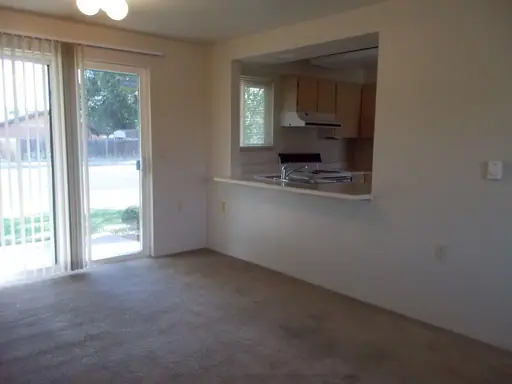 Living room with a sliding glass door and a pass-through to the kitchen