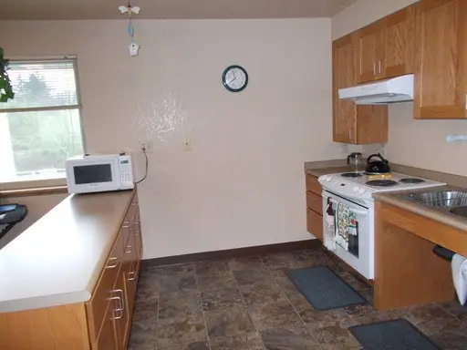 Community room kitchen with a low counter, a microwave and an electric range