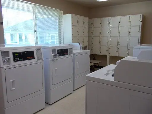 Laundry room with washers, dryers and storage lockers