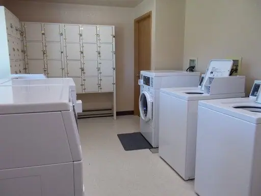 Laundry room with washers, dryers and storage lockers