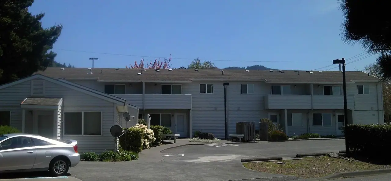 Two-story buildings around a parking lot