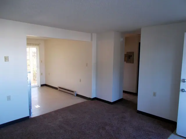 Empty living room with a doorway to a sliding door