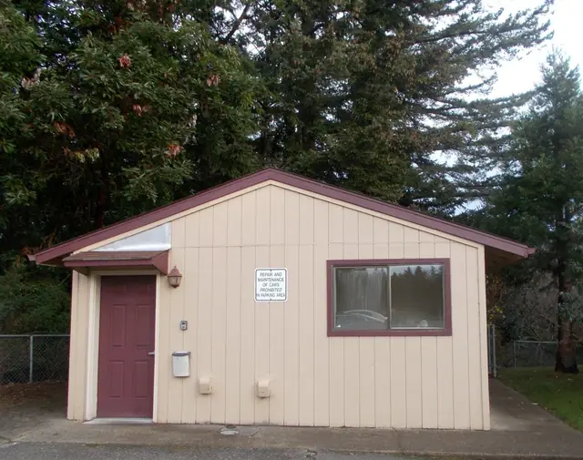 Small laundry building with a red door
