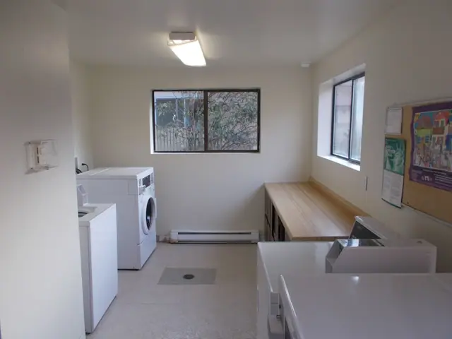 Laundry room with washers, dryers and a folding counter