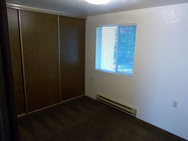 Bedroom with a sliding closet door and a window