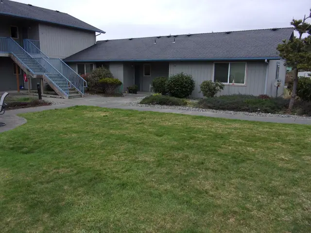 Lawn in front of the single-story and two-story buildings