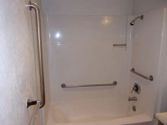 Bathtub with grab bars on two walls