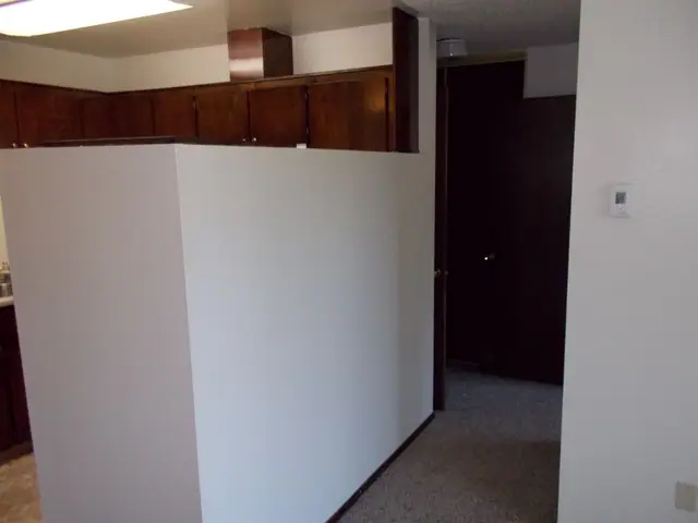 Half wall between the living area and the kitchen