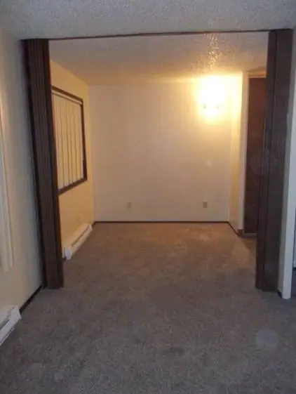 Carpeted room seen through a wide doorway