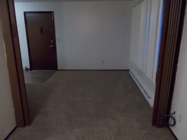 Living room with carpet and the front door