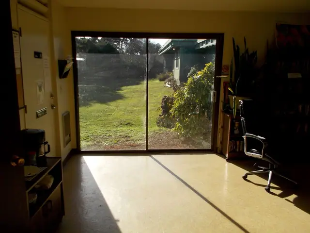 Community room with a sliding glass door to the lawn
