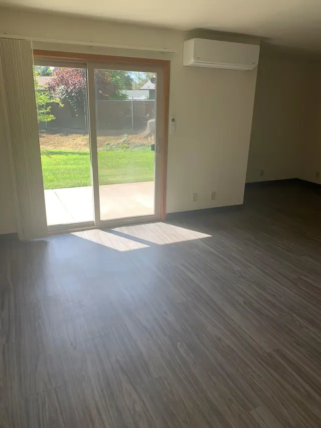 Dining area with a sliding glass door to a patio and lawn