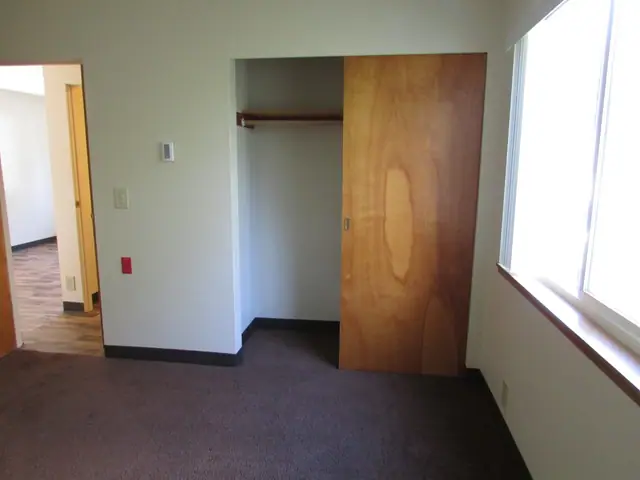 Bedroom with a sliding closet door and a window