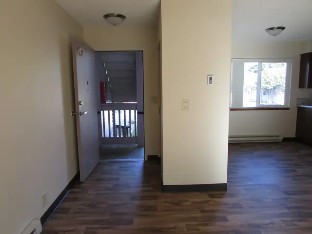 Entry with the door open to the landing, beside the living area
