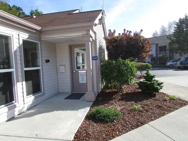 Office with a covered entry and landscaped beds
