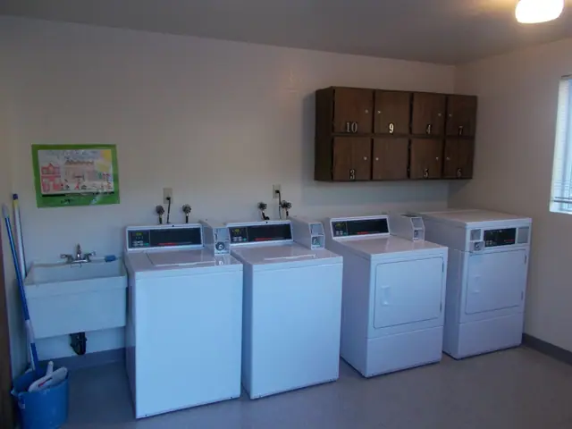 Laundry room with washers, dryers and a utility sink
