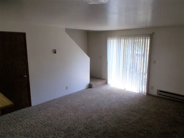 Living room with carpet and a sliding glass door