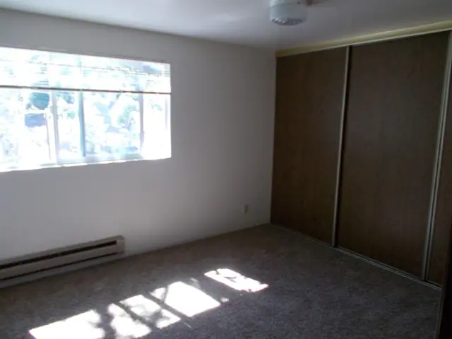 Bedroom with a sliding closet door and sun through the window