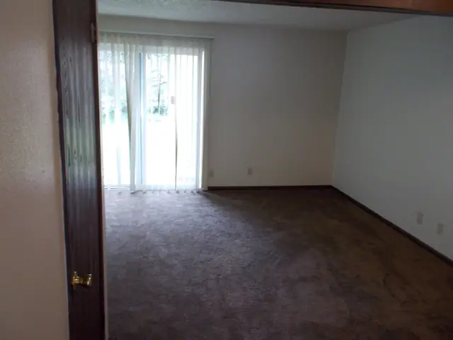 Living room with carpet and a sliding glass door