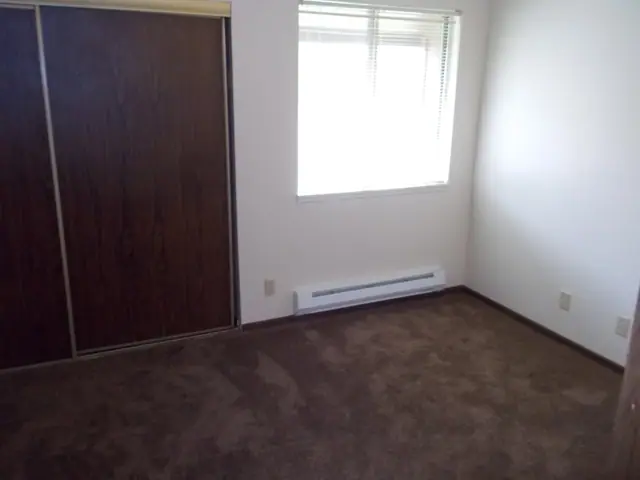 Bedroom with a sliding closet door and a window