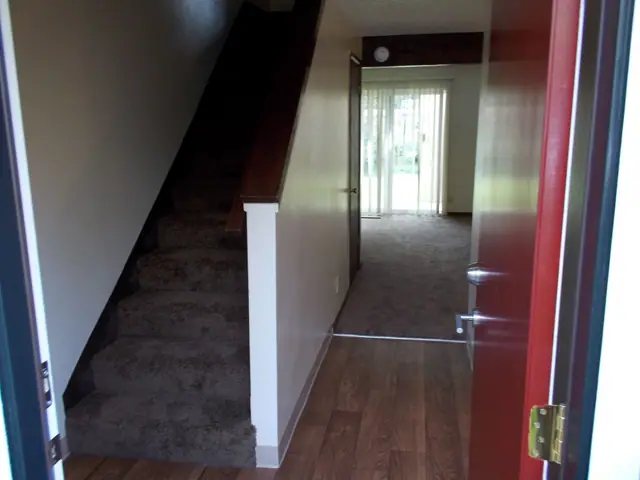 Front door opening onto the stairs and the living room