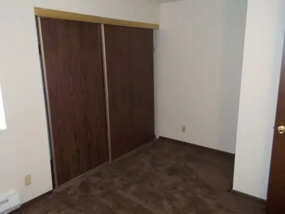 Bedroom with a wide sliding closet door