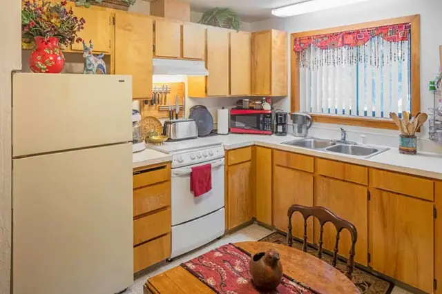 Kitchen with wood cabinets and a dining table