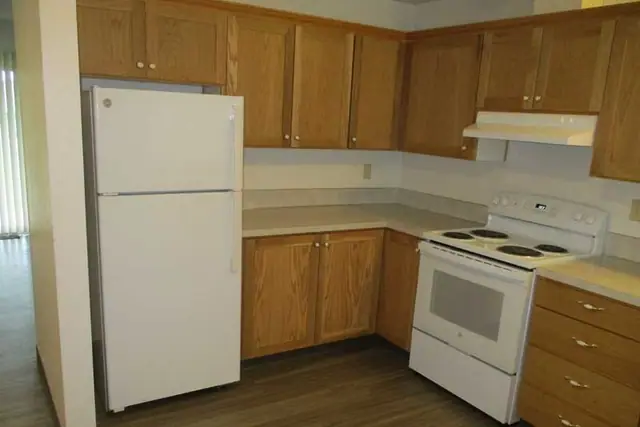Kitchen with wood cabinets, a refrigerator and an electric range