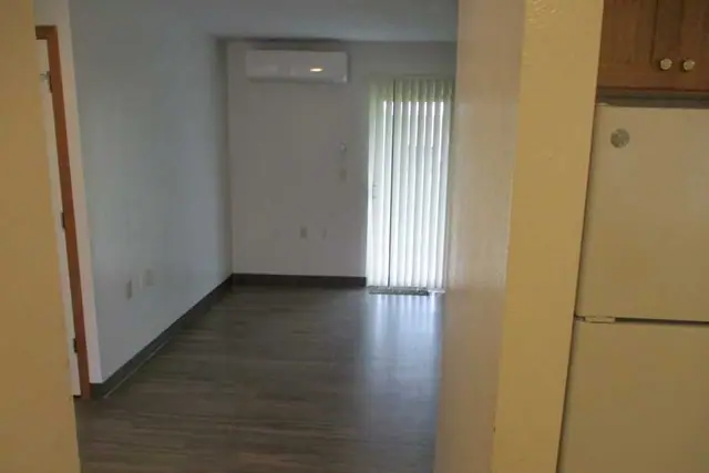 Living room with wood-look flooring and a sliding door