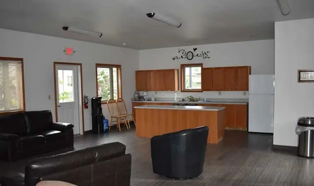 Community room with leather sofas and a kitchen island